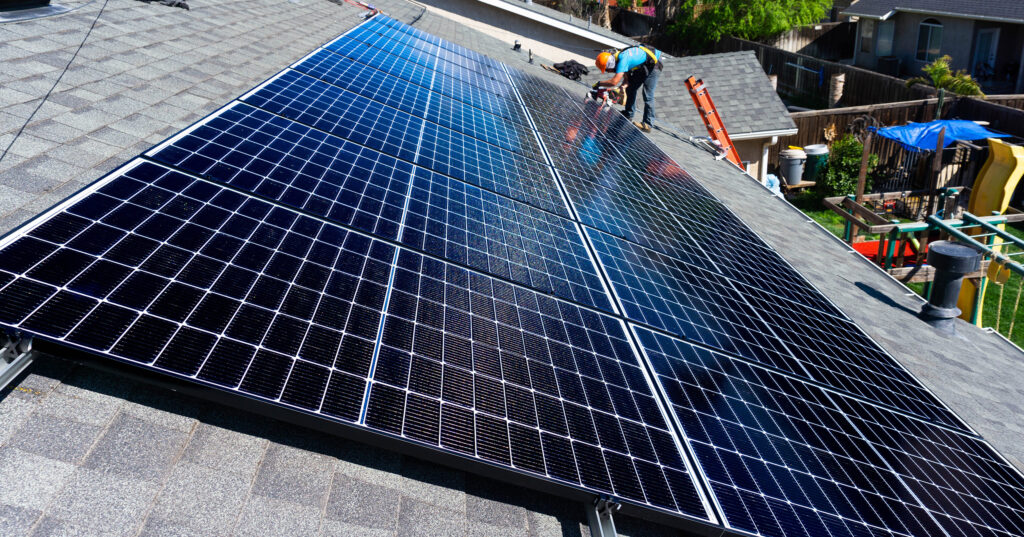 Epic installing solar panels onto a roof.