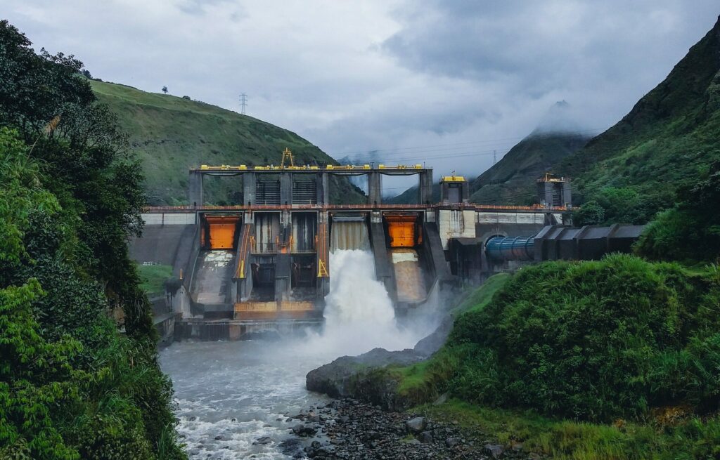 An image showing a hydroelectric power plant in the forest.