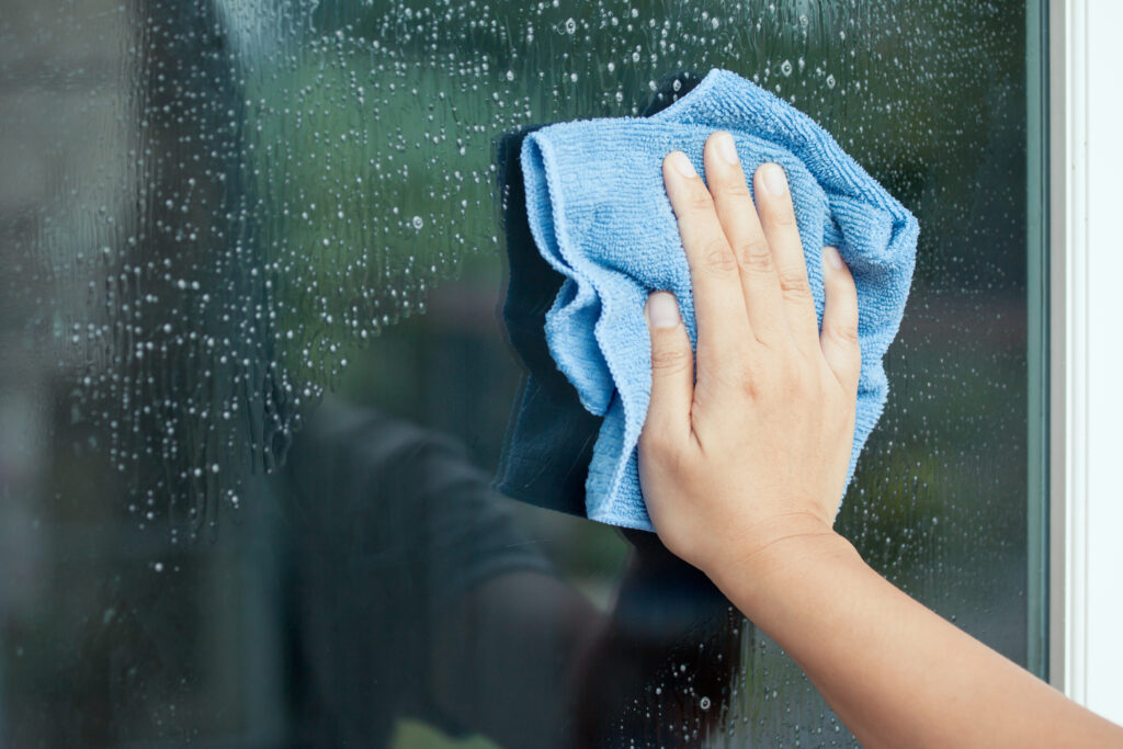 A picture of a person cleaning windows.