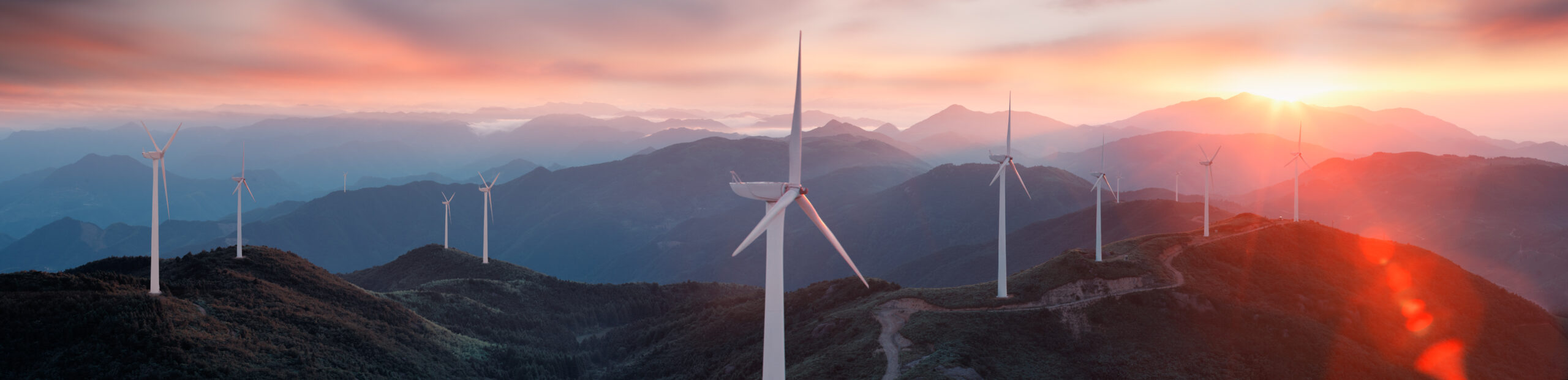 An image showing wind turbines on a mountain.