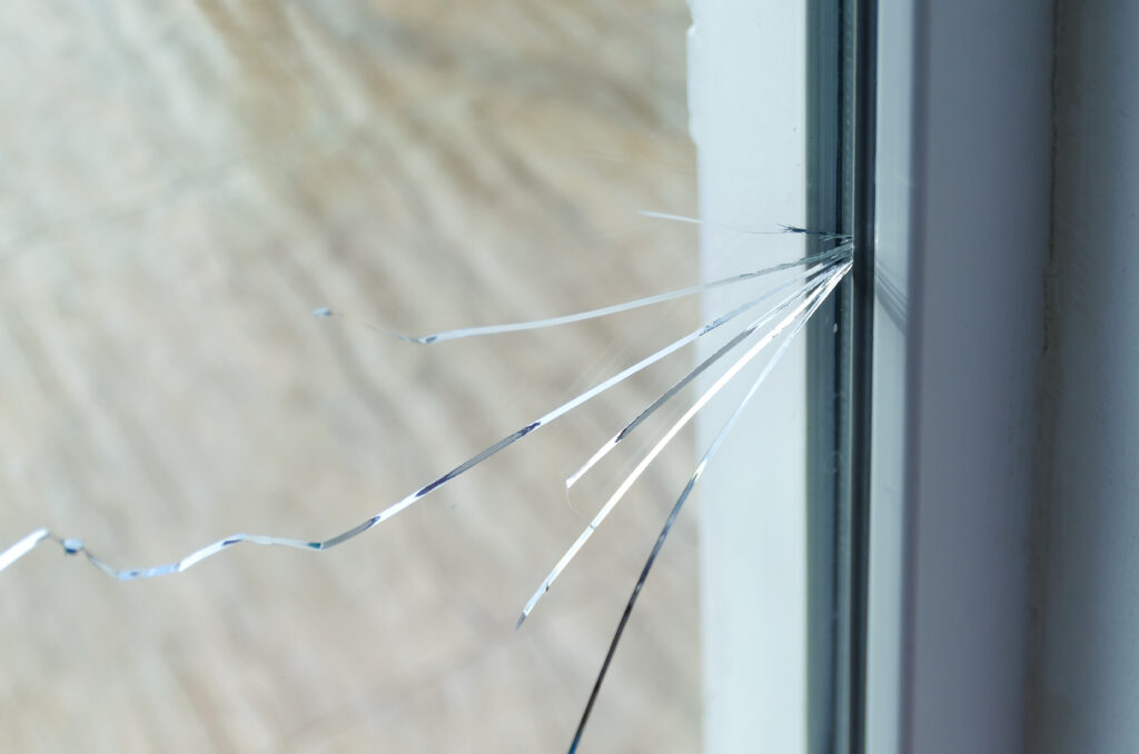 Spiderweb cracks in a window.