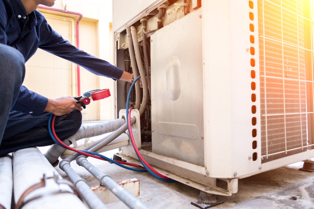 Image of a technician checking the air conditioner.