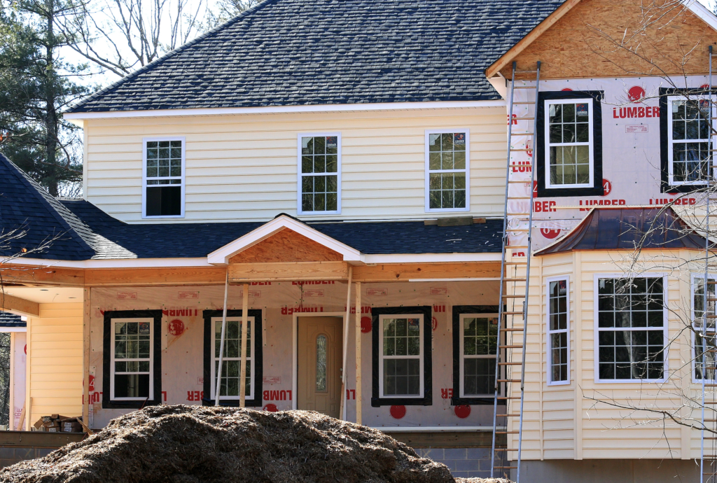 A house getting its siding put on.