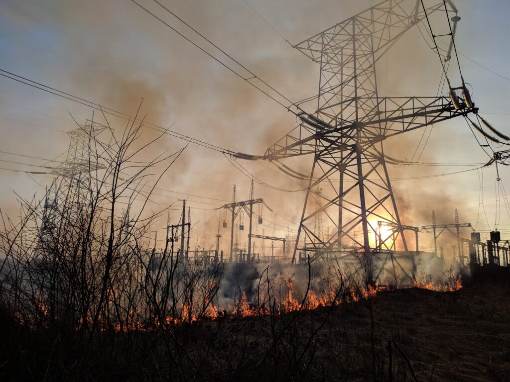 An image of power lines being burned in a wildfire.