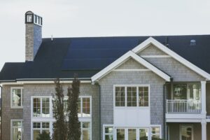 A picture of a house with solar panels installed.