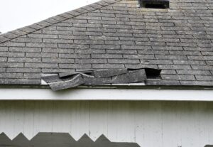 A damaged roof. The shingles are no longer connected to the base.