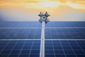 A perovskite crystal structure floating above solar panels.