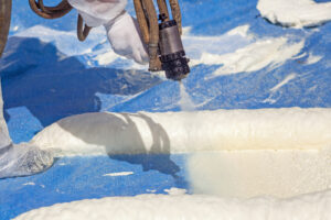 A person installing a Spray-On Roof.