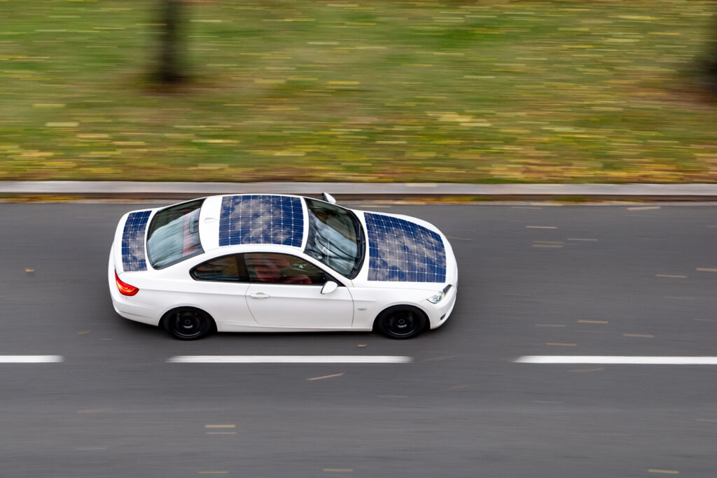 A car with solar panels on its hood and roof. 