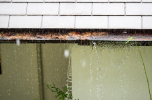 Water leaking from a clogged gutter.