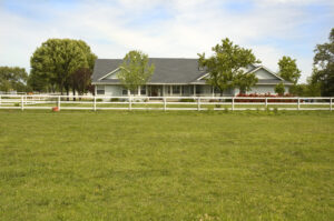 A ranch-style home seen from across a field.