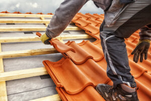 A person installing a clay roof.