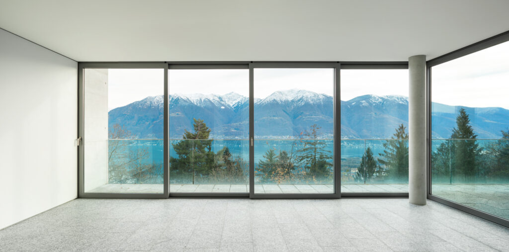 An image of floor-to-ceiling walls looking out over a snowy mountain.