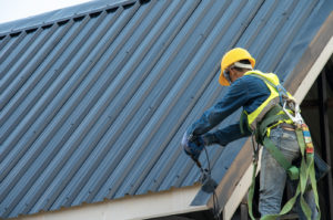 A person installing a metal roof.